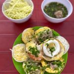 Bánh căn với các loại topping khác nhau gồm mực, tôm, trứng. Ảnh: Đông Phong