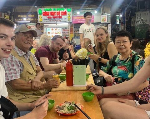 Nhóm du khách nước ngoài thưởng thức nộm bò khô tại phố cổ Hà Nội vào tháng 10. Ảnh: Tripadvisor